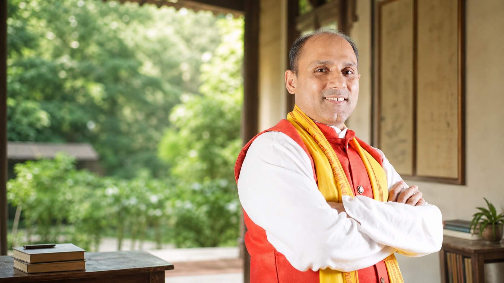 Acharya Vedshrami Ji in a green Gurukulam setting